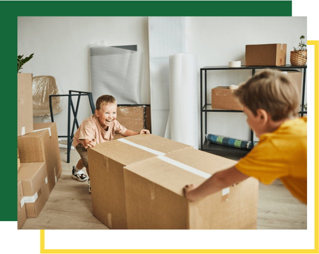 Two Boys Moving Boxes in New House