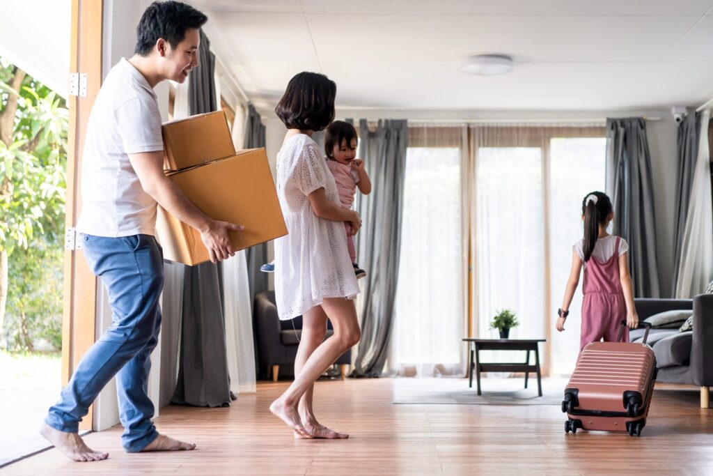 Family carrying moving boxes